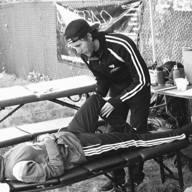 Dr. Garrett de Jong treating an athlete on-site
